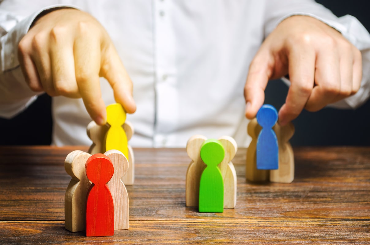 Person Managing or positioning wooden blocks to indicate how his clients are grouped.